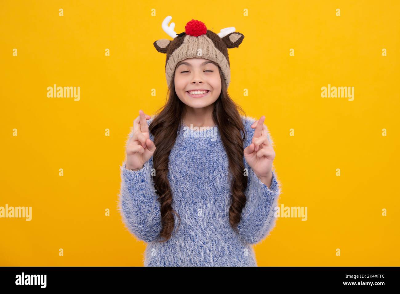 Modern teenage girl 12, 13, 14 year old wearing sweater and knitted hat