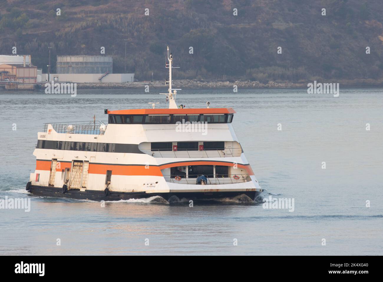 Portugal, Lisbon, September 2022 Passenger ferryboat coming to the pier on Tejo river, sea transportation and traveling, morning Stock Photo