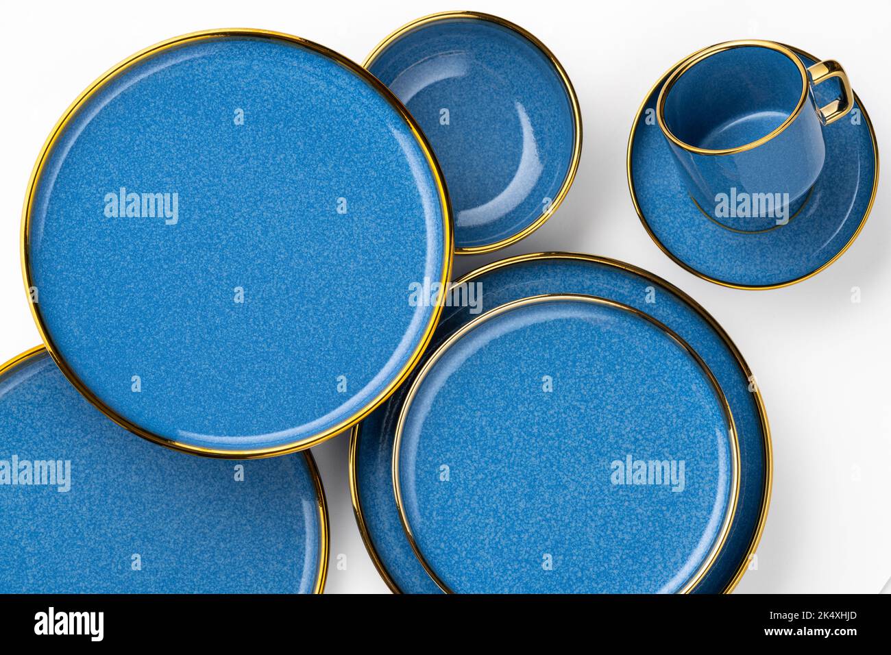 A Set of blue ceramic plates and cup on a white background Stock Photo