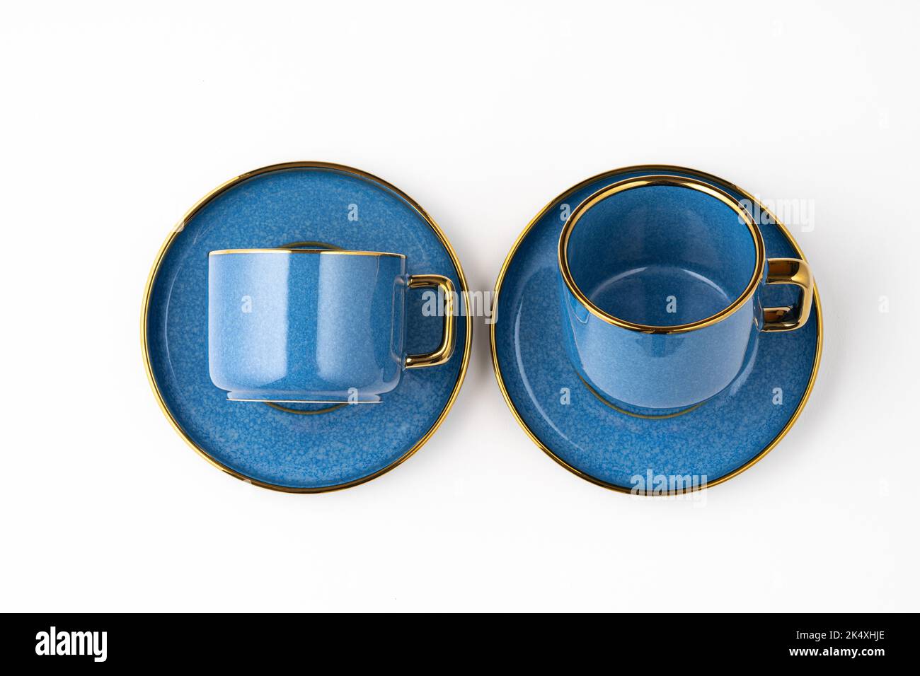 A Set of blue ceramic plates and cup on a white background Stock Photo