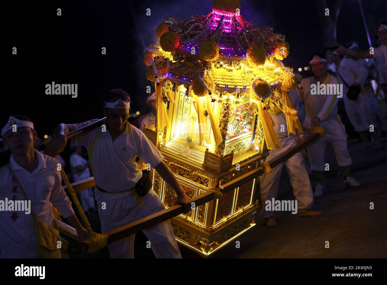 Devotees carrying a chariot take part in a ritual to send off the gods into the sea during the last day of the Taoist Nine Emperor Gods festival in Singapore October 4, 2022. REUTERS/Edgar Su Stock Photo