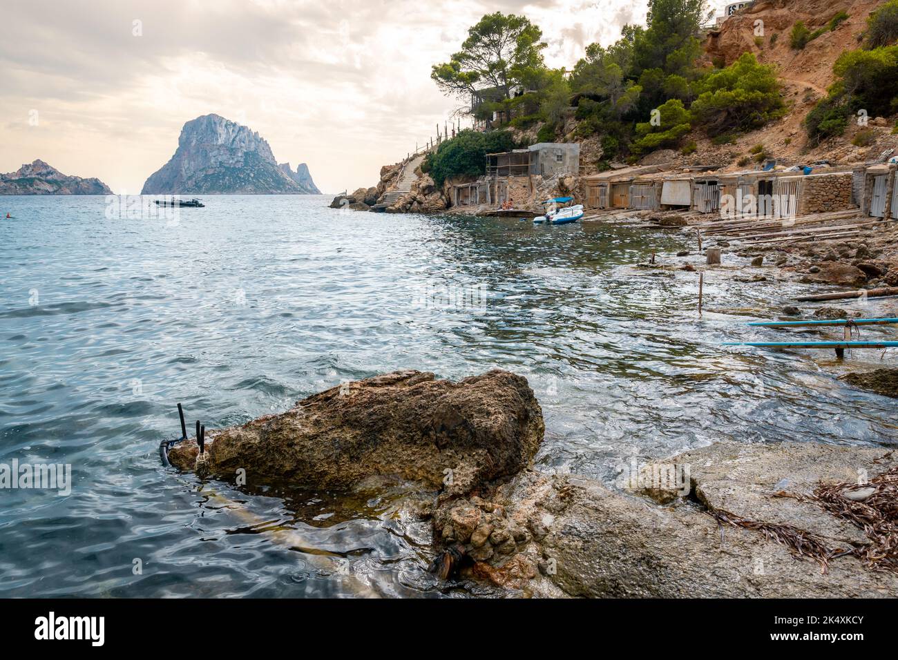 View of Es Vedra and boat garages Stock Photo