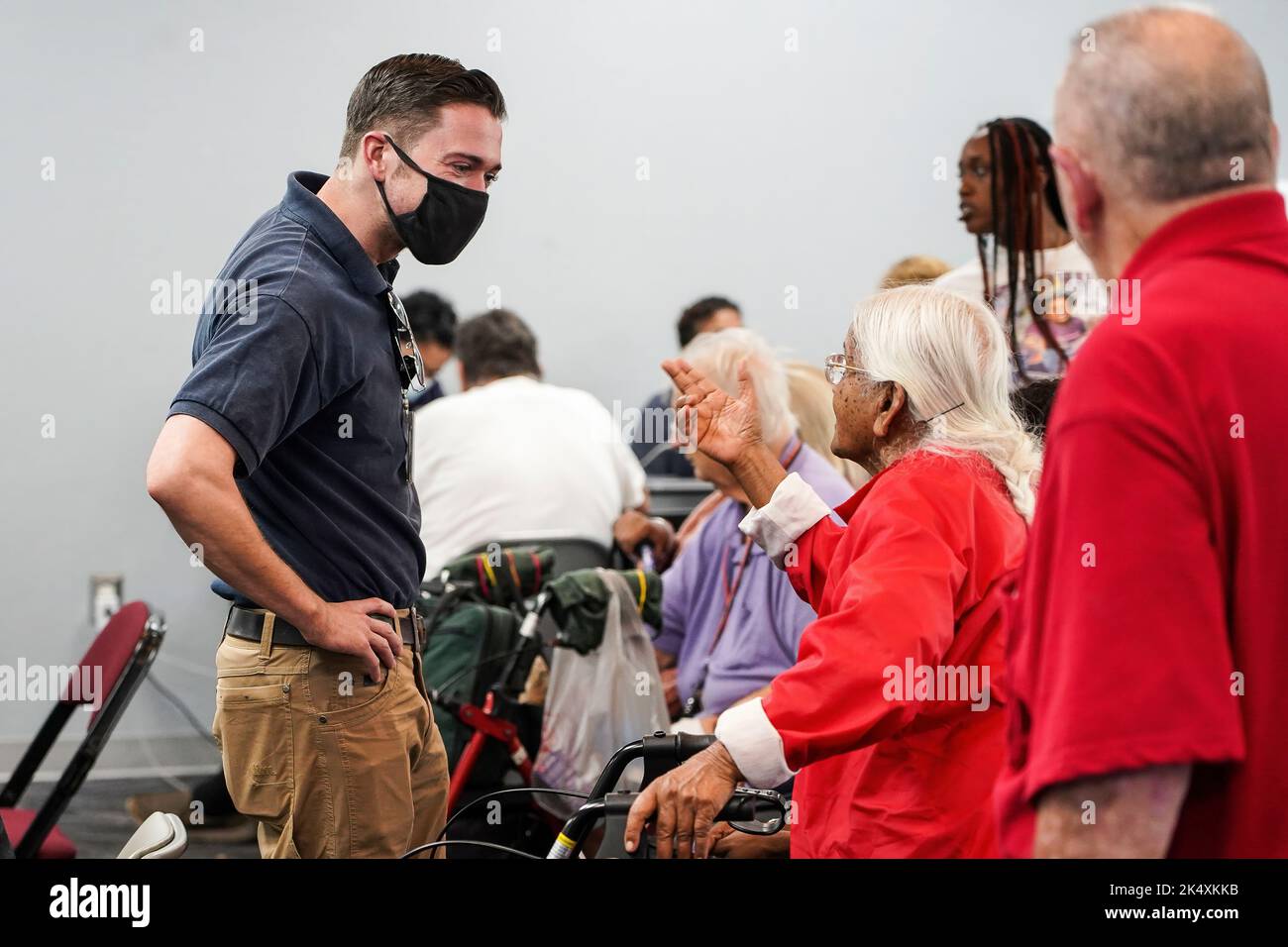 Kissimmee, FL, (Oct. 2, 2022) - FEMA Disaster Survivor Assistant helps Hurricane Ian survivor at the Kissimmee Civic Center to apply for recovery assistance. Robert Kaufmann/FEMA Stock Photo