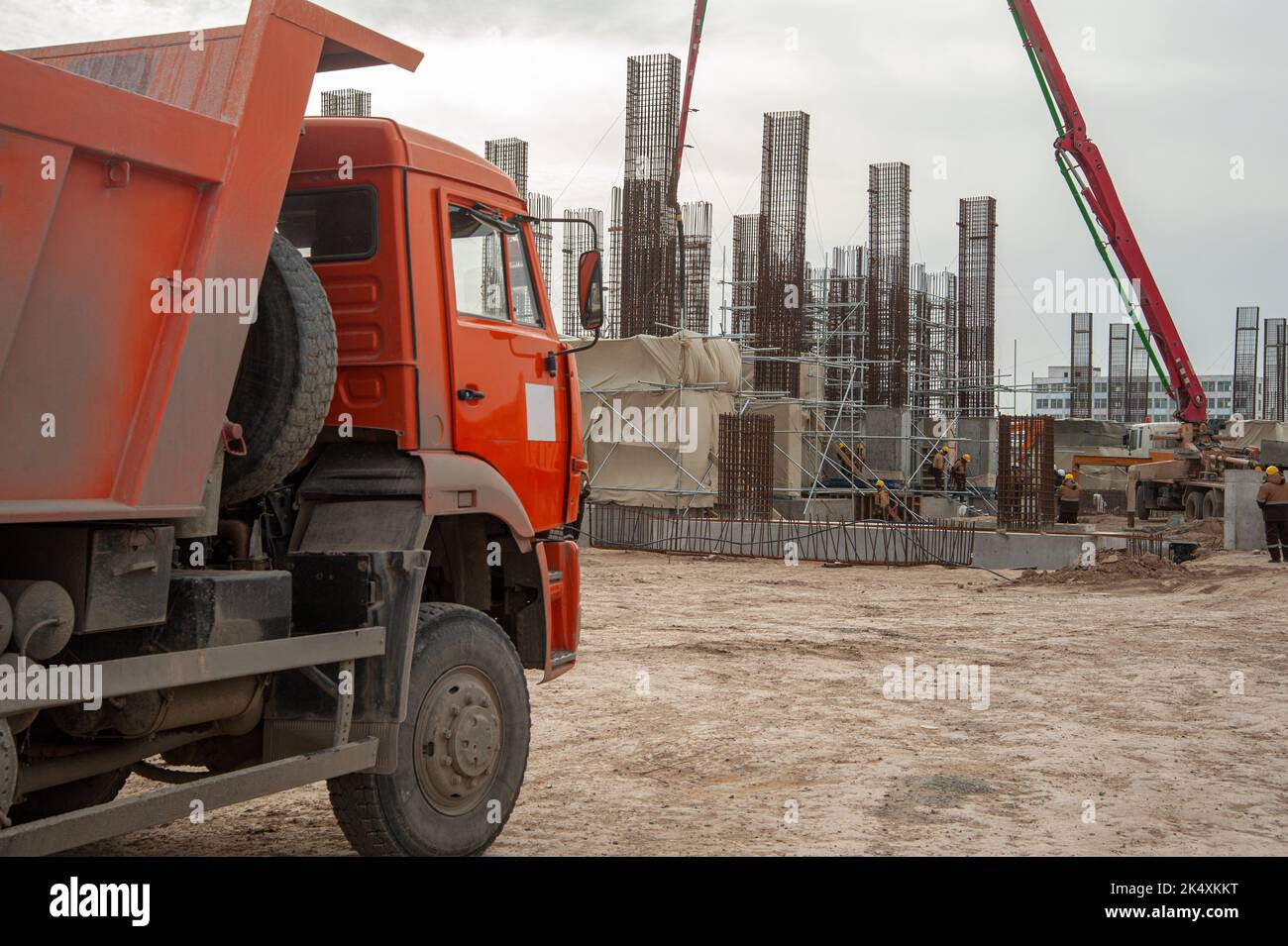 An Orange dumper truck in an construction area Stock Photo - Alamy