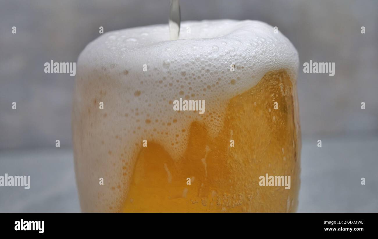 Macro Shot Of Pouring Beer Into Glass Stock Photo