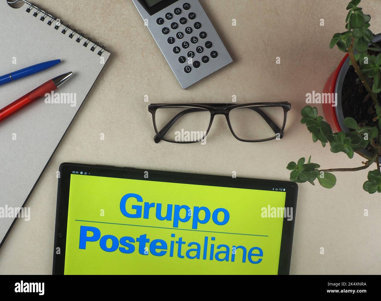 In this photo illustration, Poste Italiane Sp A. logo seen displayed on a tablet. Stock Photo
