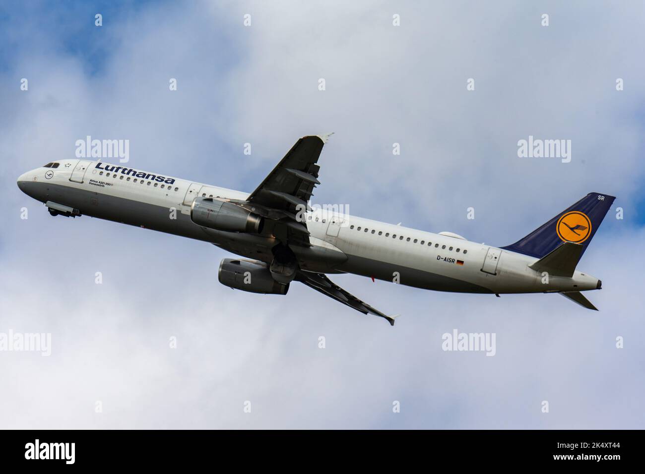 A beautiful view of a plane  Lufthansa Airbus A321-200, sorrowing through the bright blue sky Stock Photo
