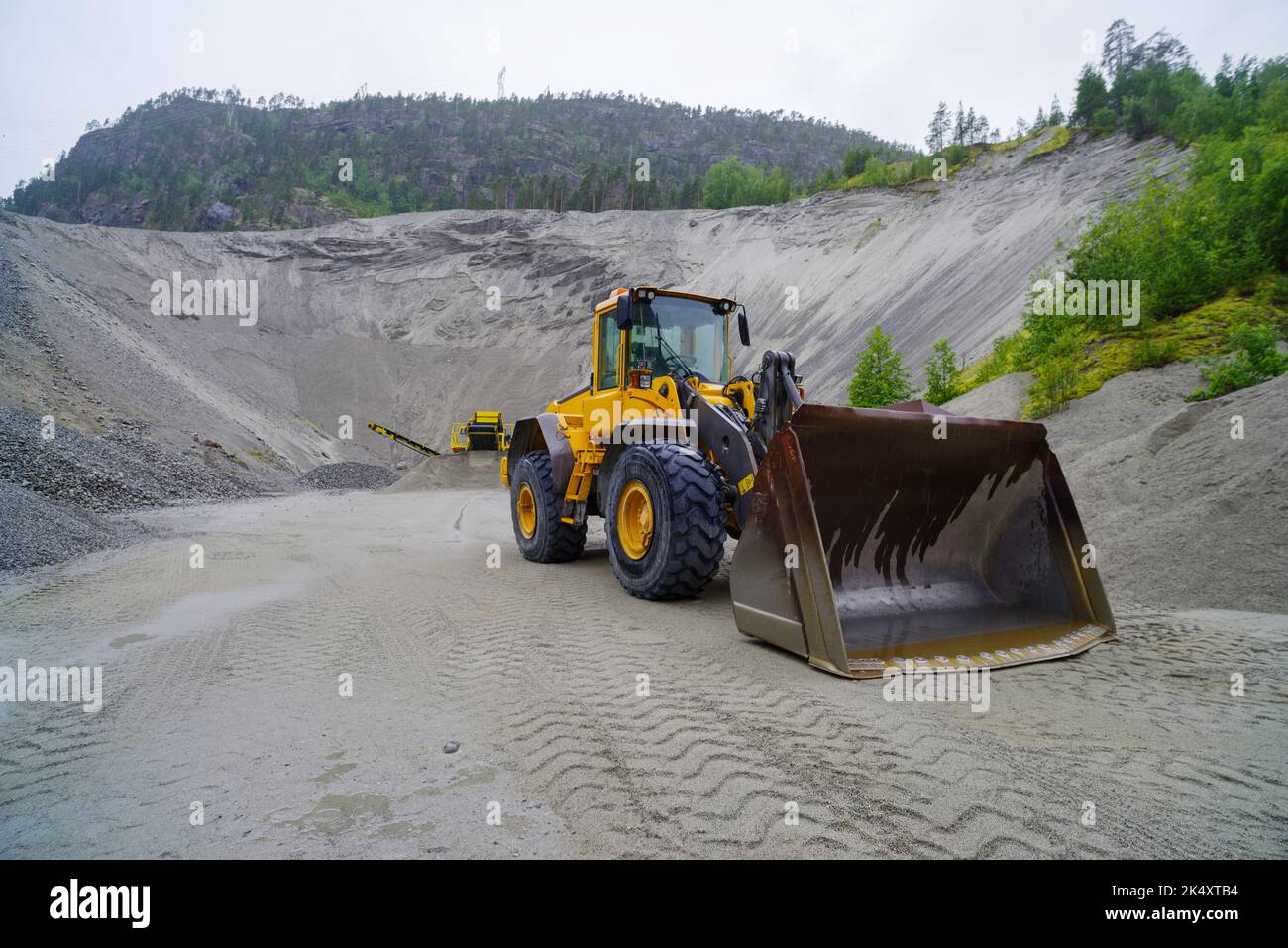 yellow excavator with an enormous scoop in a sand quarry Stock Photo ...