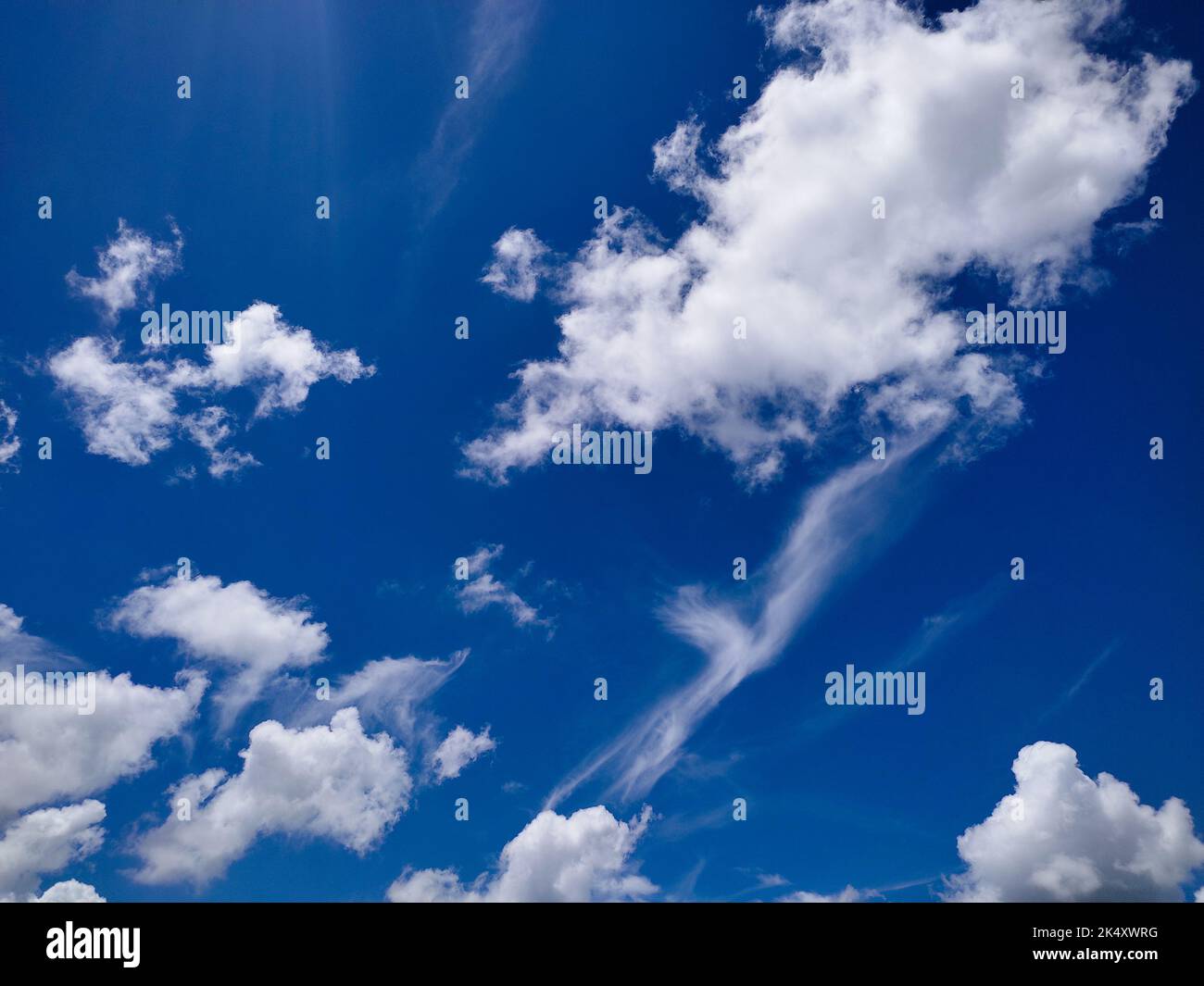 An amazing view of blue sky with fluffy white clouds as a background ...