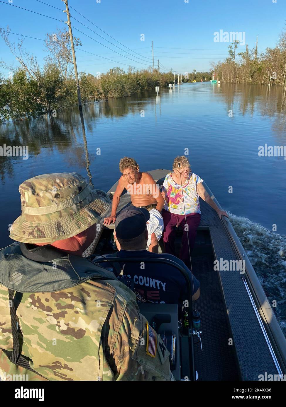 Florida National Guard Soldiers transport residents during Hurricane Ian relief efforts in Arcadia, Fla., Oct. 3, 2022. Florida National Guard's Chemical, Biological, Radiological/Nuclear, and Explosive (CBRNE) - Enhanced Response Force Package (FL-CERFP) conducted search and rescue operations alongside first responders through flooded areas across South West Florida. Hurricane Ian left many residents unable to evacuate their homes safely due to rising water. CERFP deployed all available ground and maritime vessels in support of continuous missions in order to ensure the safety of the communit Stock Photo