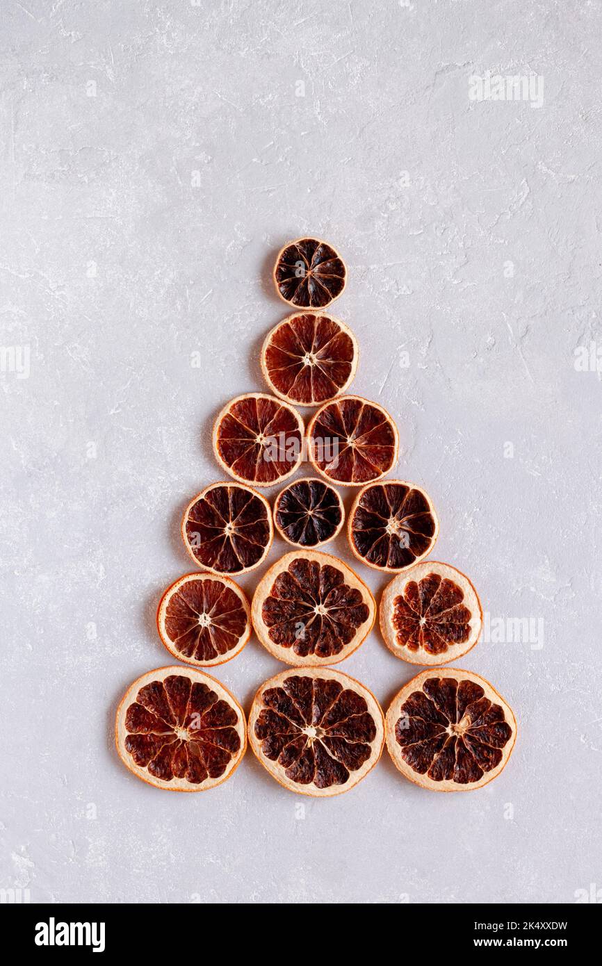 Christmas tree made of dry orange slices, minimalism, zero waste idea, top view Stock Photo