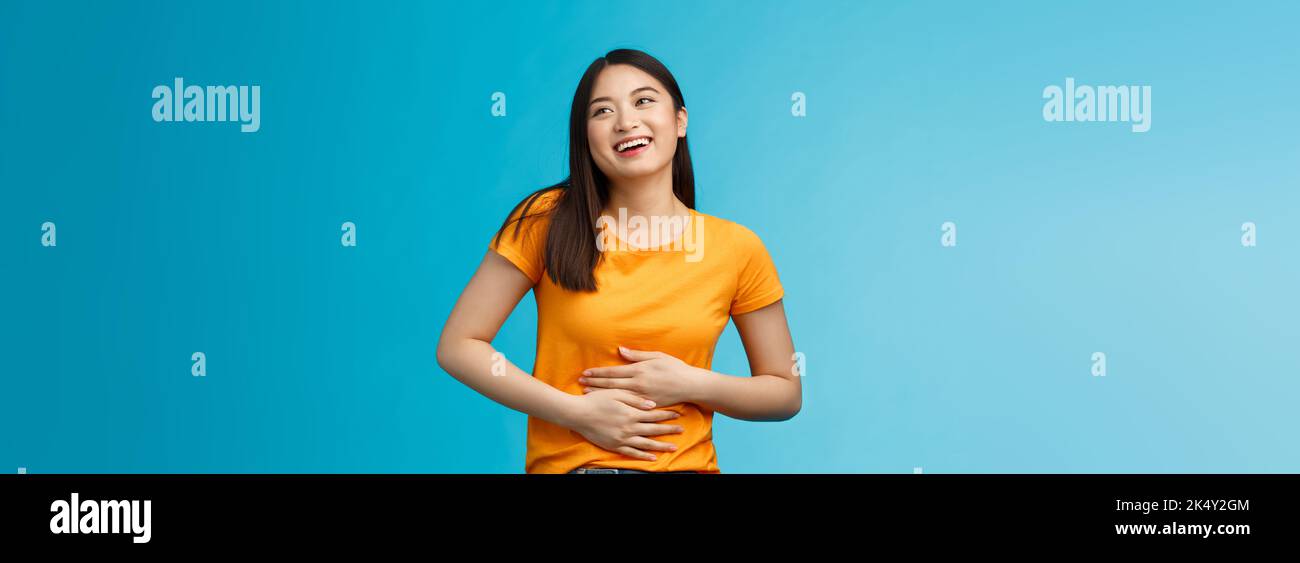 Happy staffed cute asian girl feelings satisfaction after eating