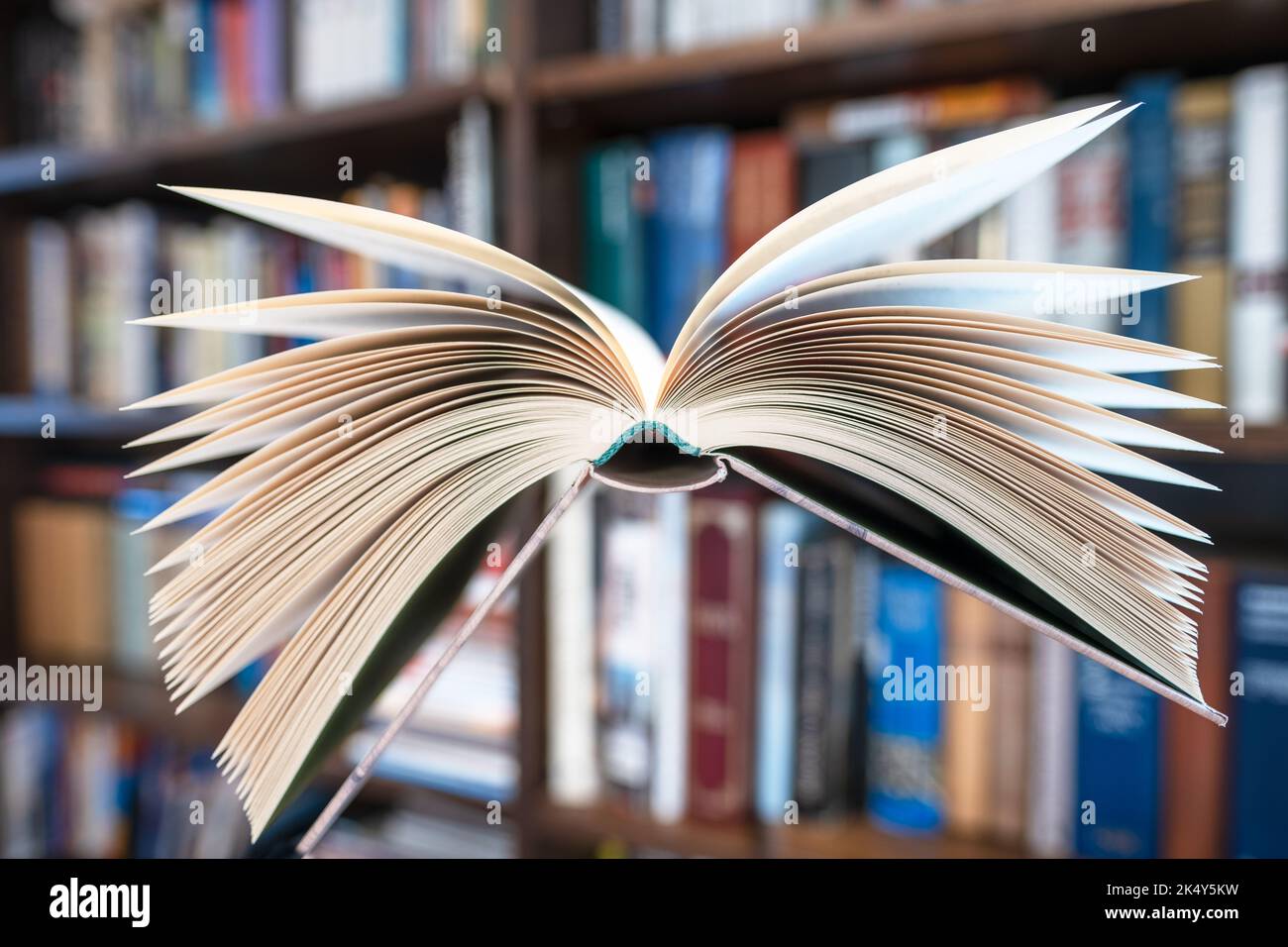 Flying open book in library Stock Photo