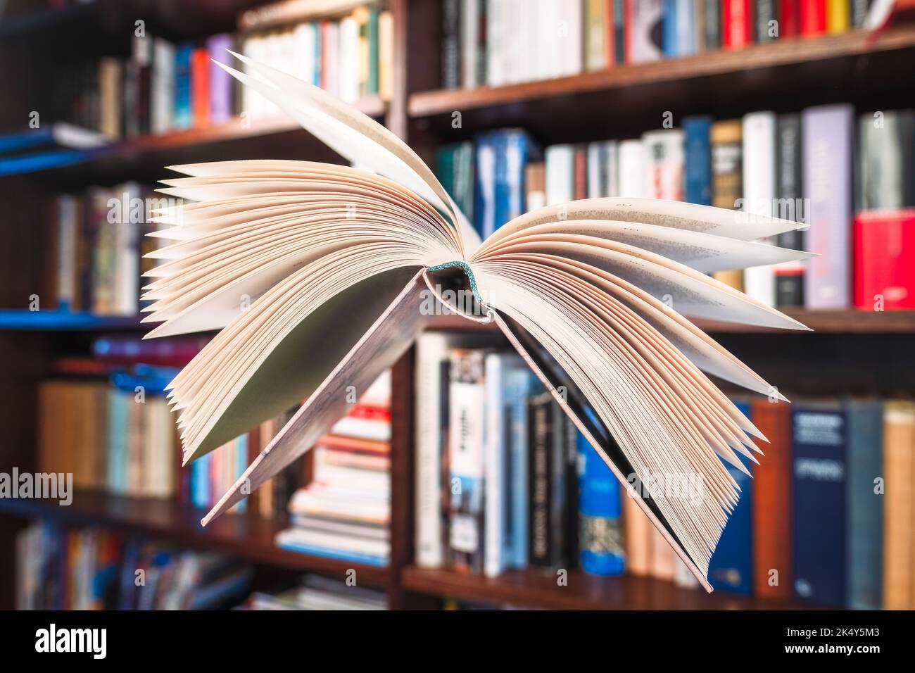 Flying open book in library Stock Photo