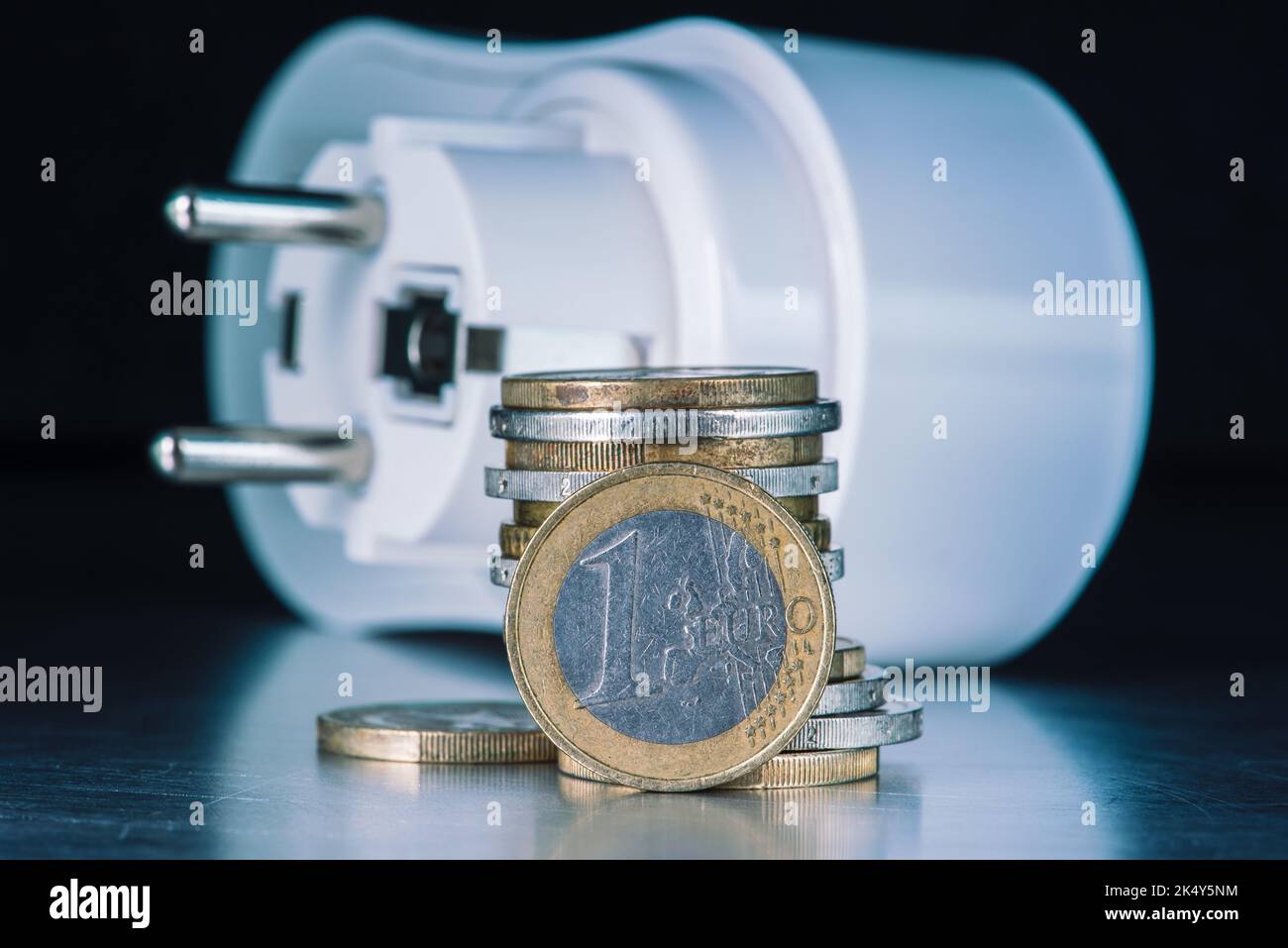 Euro coins and electrical plug, concept of inflation and increasing energy prices Stock Photo