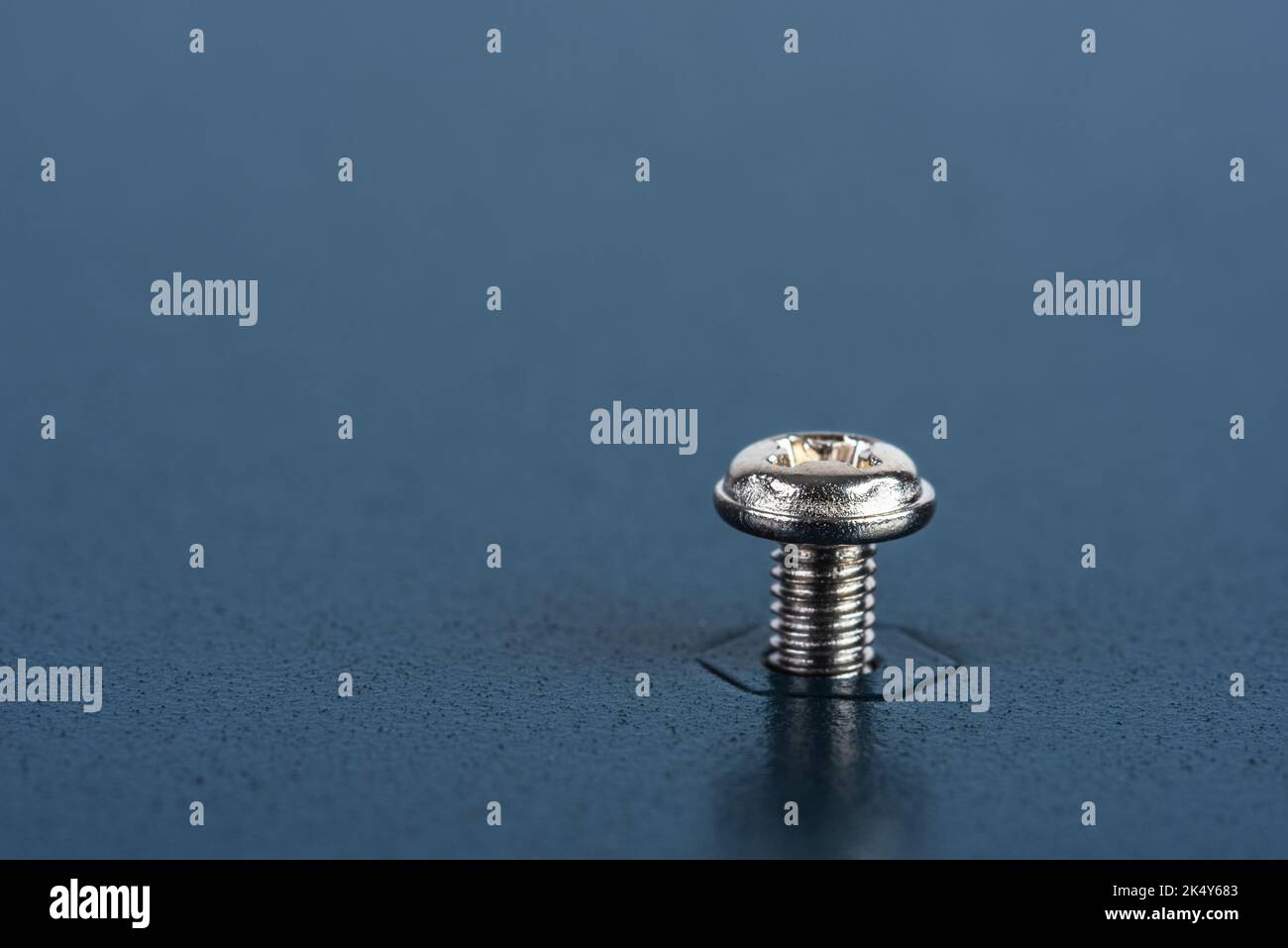 Single Screw and Nut in Metal Surface Texture Stock Photo