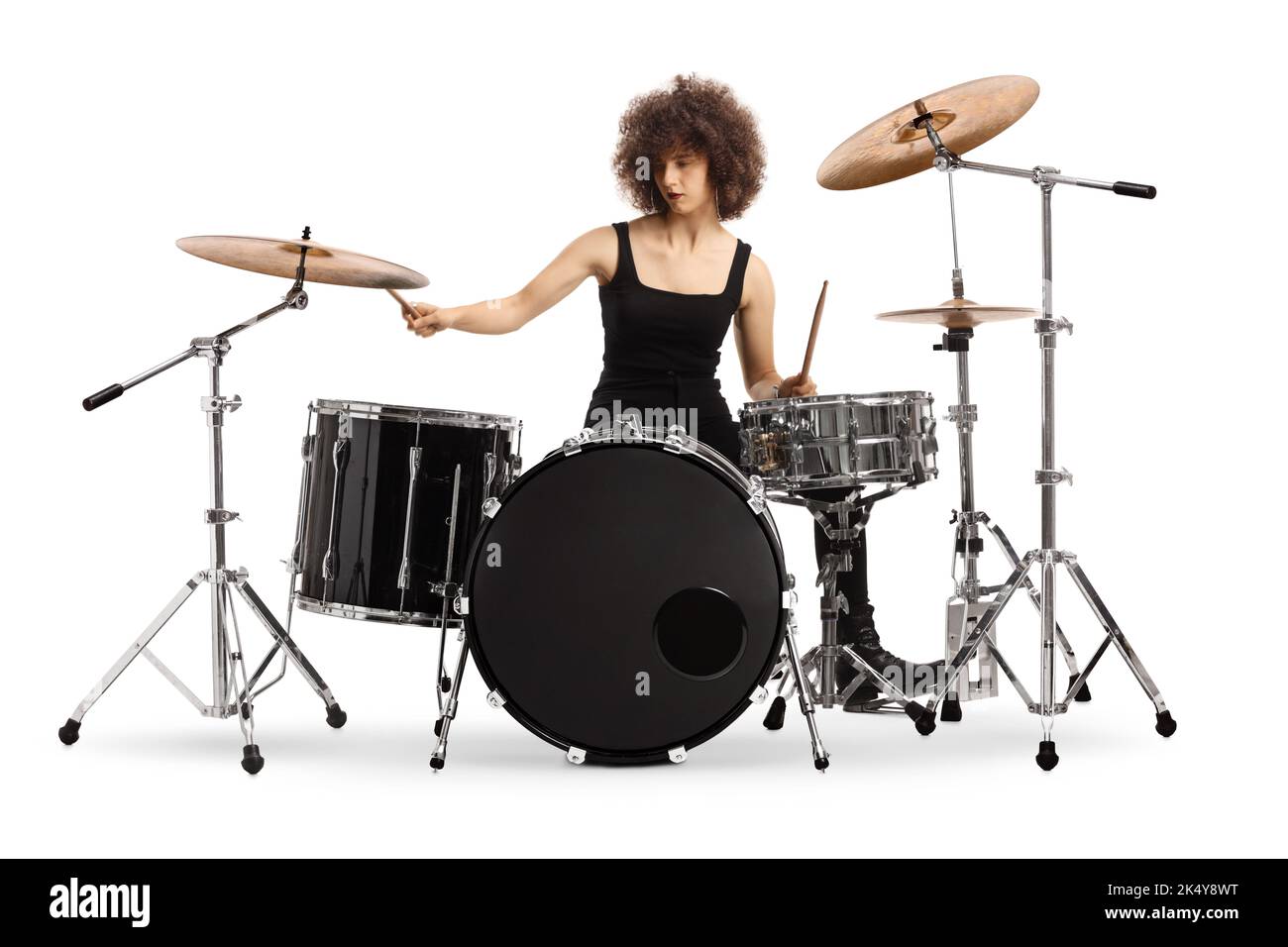 Female rock musician playing drums isolated on white background Stock Photo