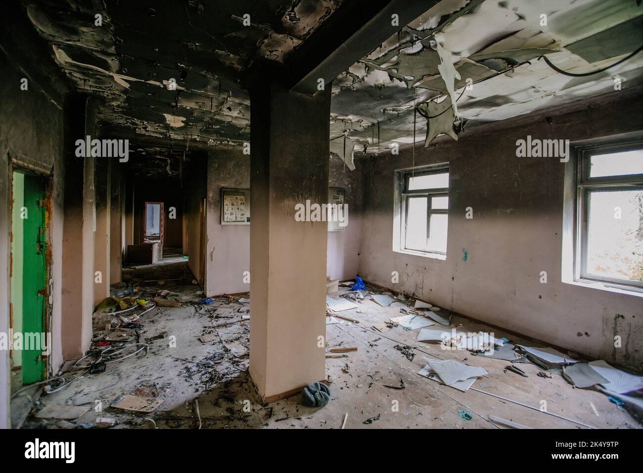 Burnt school interior. Charred walls in black soot. Consequences of