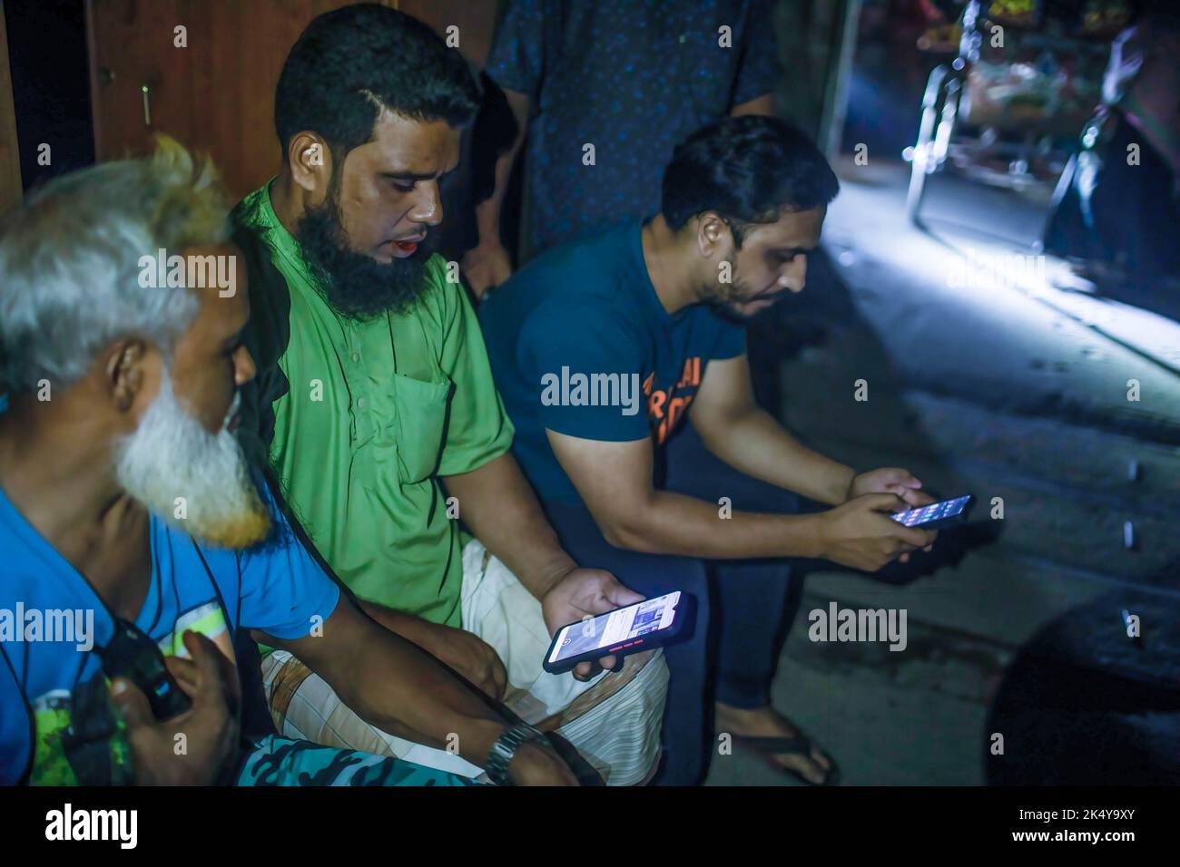 Dhaka, Bangladesh. 4th Oct, 2022. People seen on their phones outside