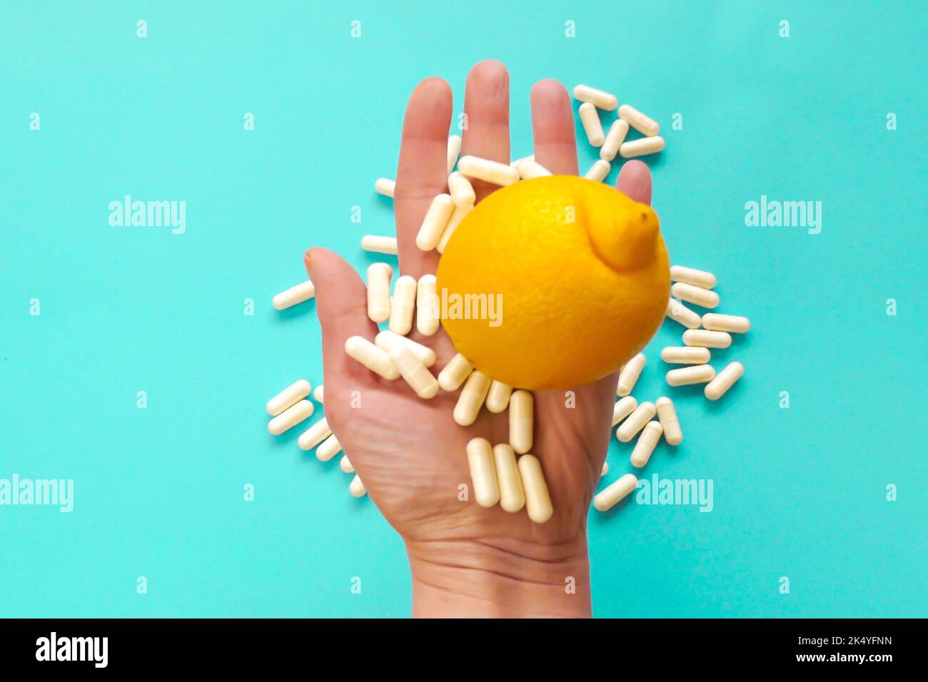 Taking vitamin C tablets.White capsules of vitamin C in a hand and