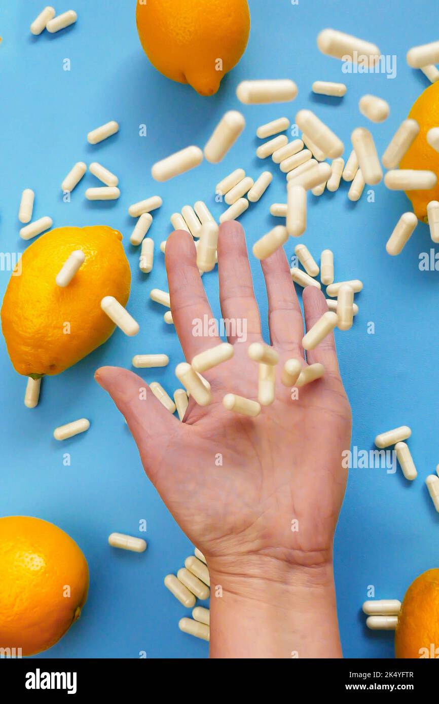 Vitamin C.Taking vitamin C tablets.White capsules of vitamin C in a