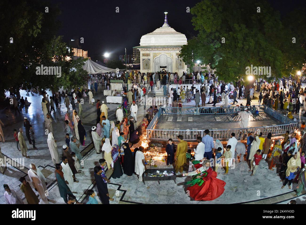 Pakistani Muslim devotees light candles earthen oil lamps and devotees (Malang) dance at the shrine of famous fifteenth century Sufi Saint Hazrat Mir Mohammed Muayyinul during 399th URS birth anniversary celebrations in Lahore. Thousands of people across the country visit the shrine to pay tribute to him during a three-day festival. The saint was equally popular among the Muslim and Sikh religions, as Mian Mir went to Amritsar (India) in December 1588 to lay the foundation stone of Sikh's holiest site, the Golden Temple, which is commonly known as Sri Harminder Sahib. (Photo by Rana Sajid Huss Stock Photo