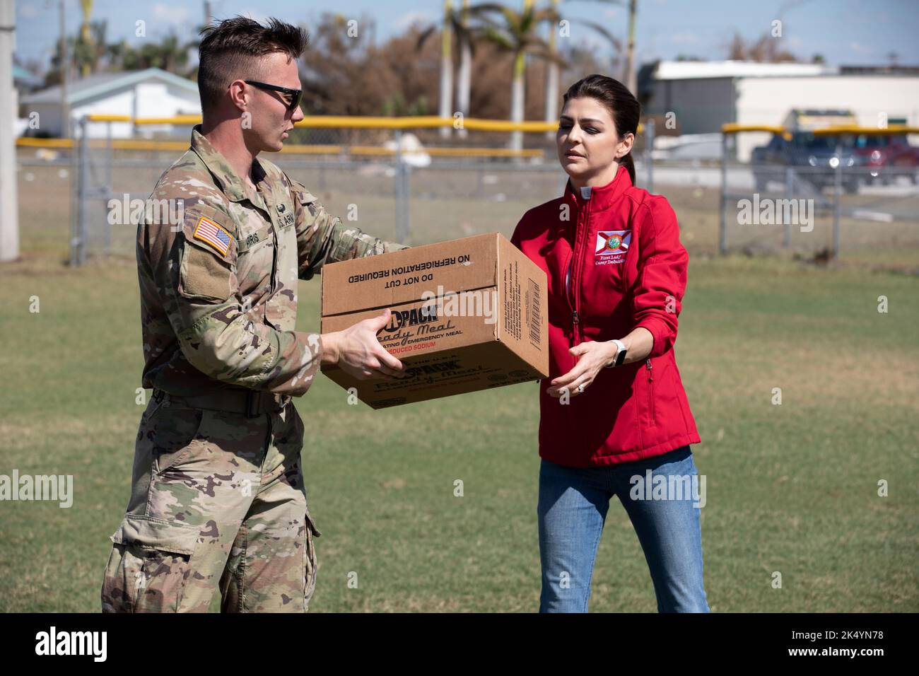 Pine Island, United States. 03rd Oct, 2022. A U.S. Army soldier with the Florida National Guard hands a box to the First Lady of Florida, Casey DeSantis, during an emergency food drop in the aftermath of the massive Category 4 Hurricane Ian, October 3, 2022 in Pine Island, Florida. Credit: Pfc. Alexander Helman/US Army/Alamy Live News Stock Photo