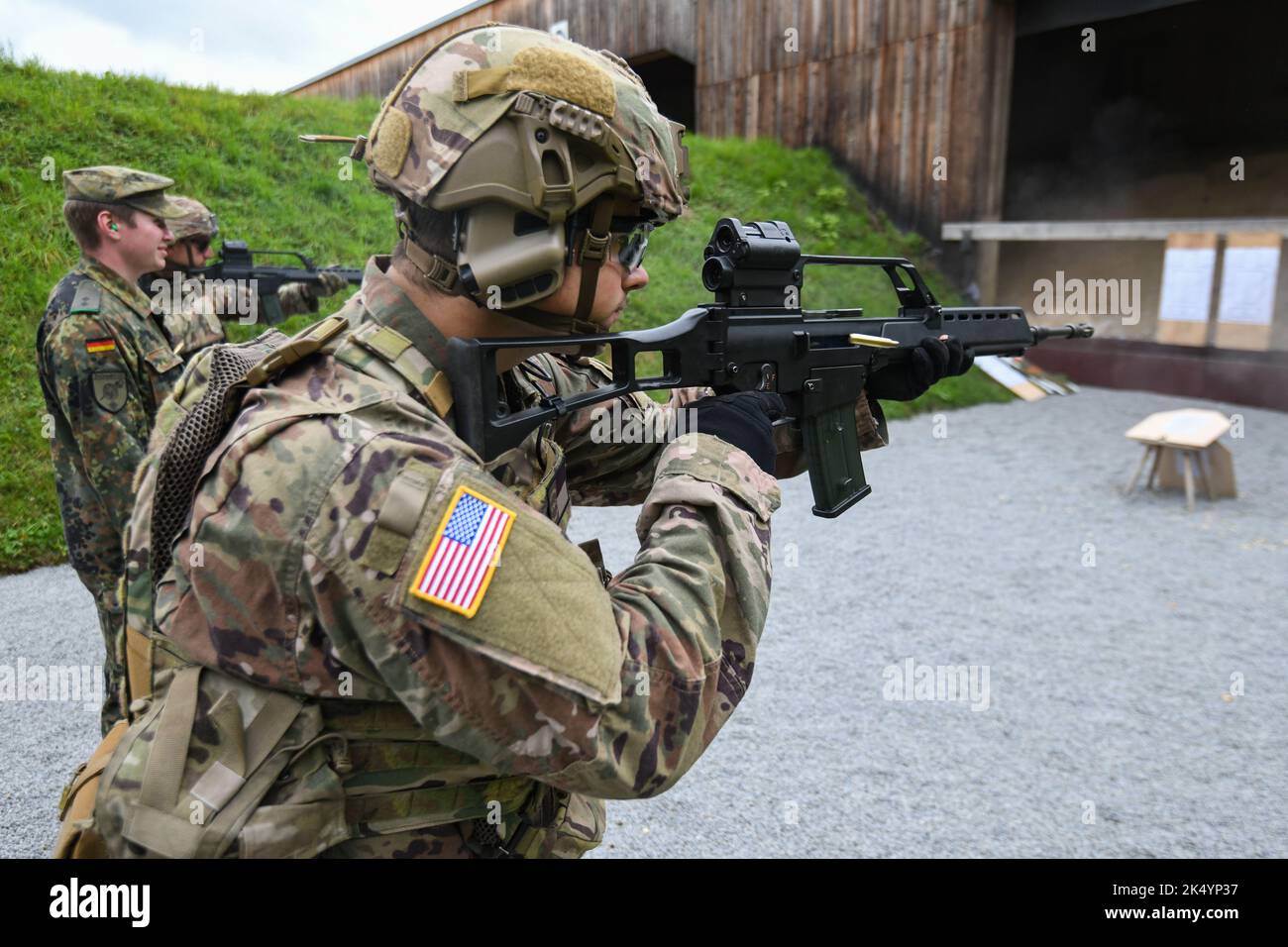 A U.S. Soldier assigned to 1st Squadron, 2nd Cavalry Regiment (1/2CR) fires a German G36 rifle during a Schuetzenschnur (German weapons proficiency test) event with the German partner unit of 1/2CR, the Panzergrenadierbataillon 112, at Regen, Germany, Sept. 29, 2022. 1/2CR provided an opportunity for exemplary Soldiers to earn a foreign award and to build camaraderie with German Army counterparts in order to strengthen NATO and multinational partnerships. (U.S. Army photo by Markus Rauchenberger) Stock Photo