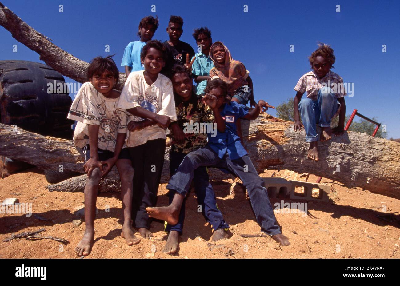 GROUP OF HAPPY YOUNG INDIGENOUS TEENAGERS AND YOUNGER BOYS, YUWELAMU, NORTHERN TERRITORY. Stock Photo
