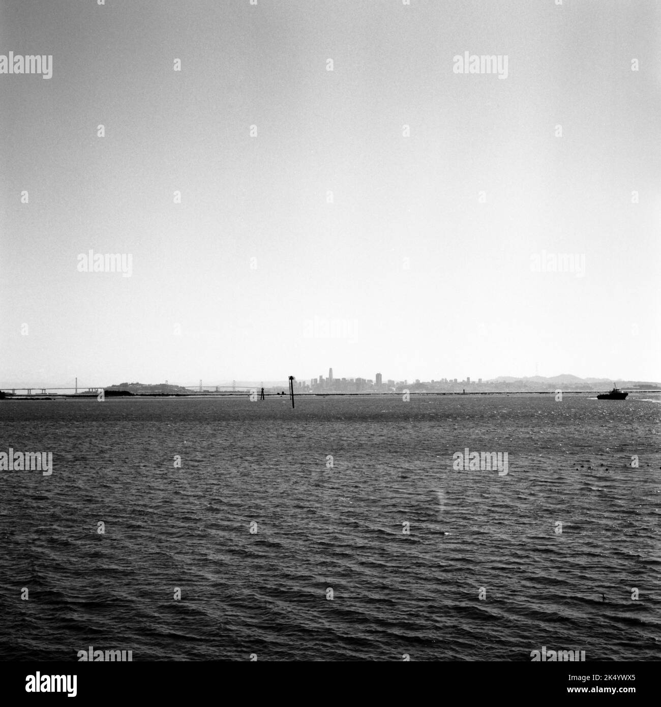 An aerial view of Bay area with floating boat in black and white Stock