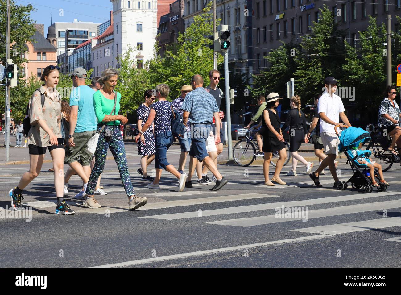 Helsinki, Finland - August 20, 2022: People at a crosswalk near the Hakaniemi square. Stock Photo