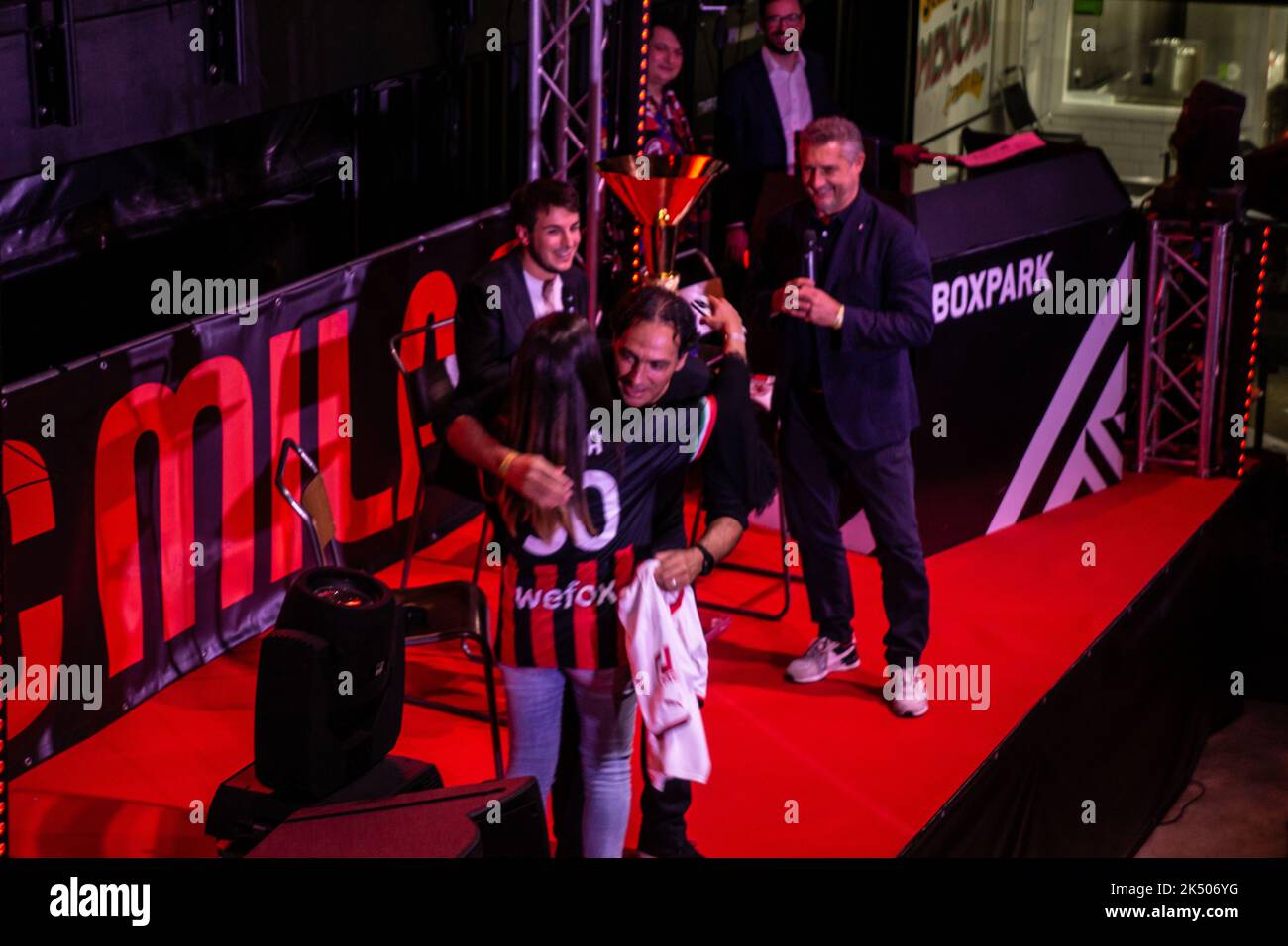 London, United Kingdom. 4th Oct 2022. From Milan to Many: Italian Serie A champions AC Milan show their trophy to supporters in London ahead of their Champions League clash with Chelsea FC. Alessandro Nest hugs fan Giorgia on stage, celebrating her birthday. Cristina Massei/Alamy Live News Stock Photo