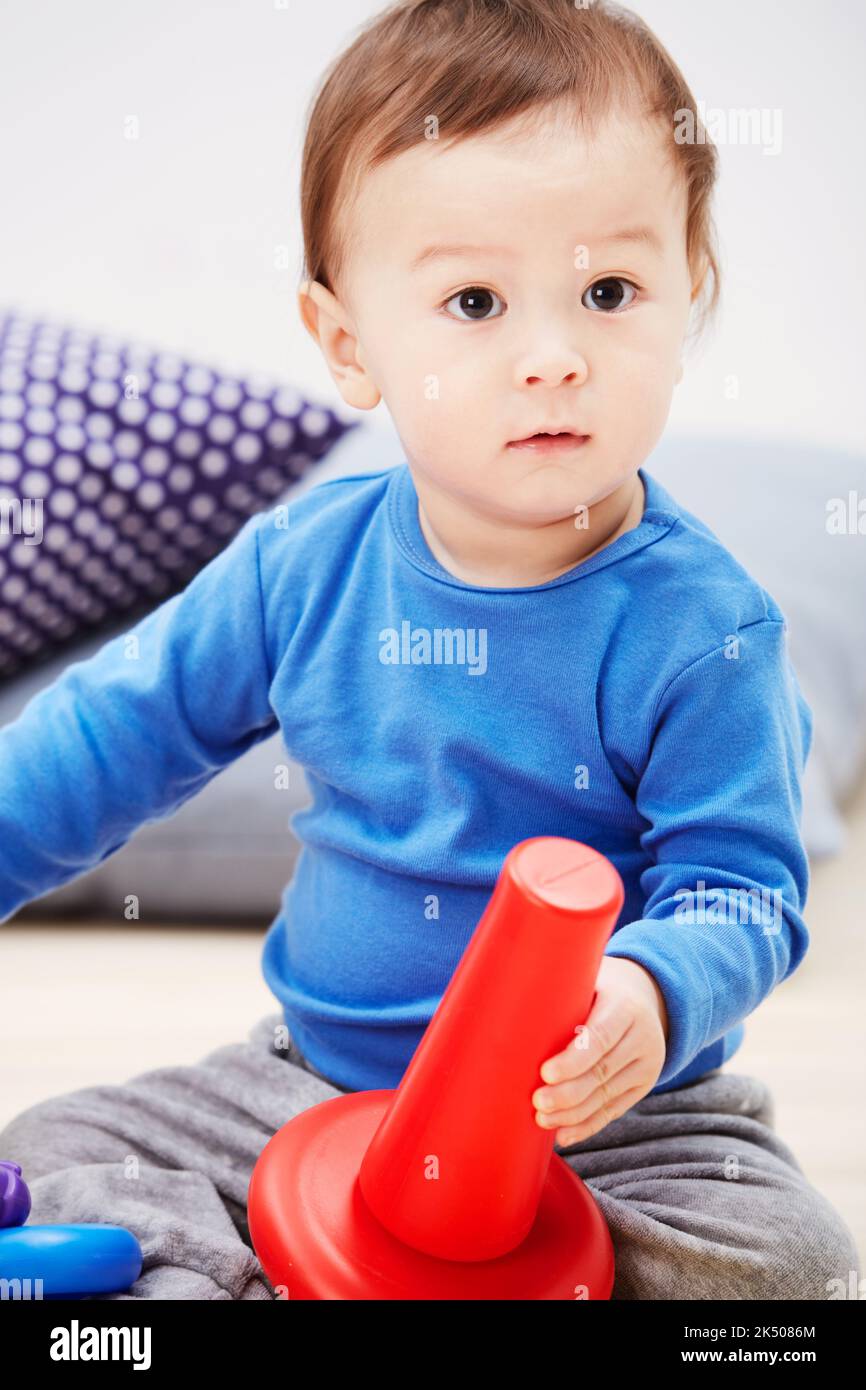 Learning new skills...a cute baby boy playing with his toys Stock Photo ...