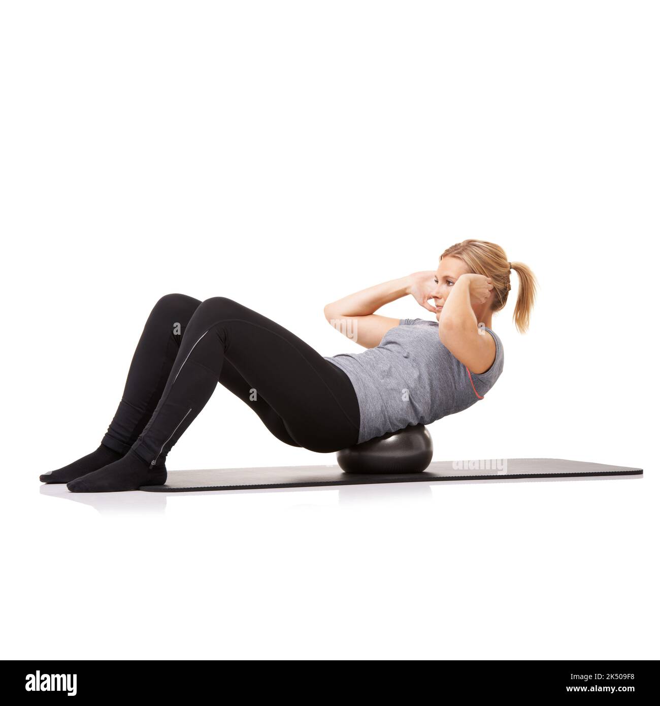 Crunches with an exercise ball. A young woman doing sit-ups on an ...