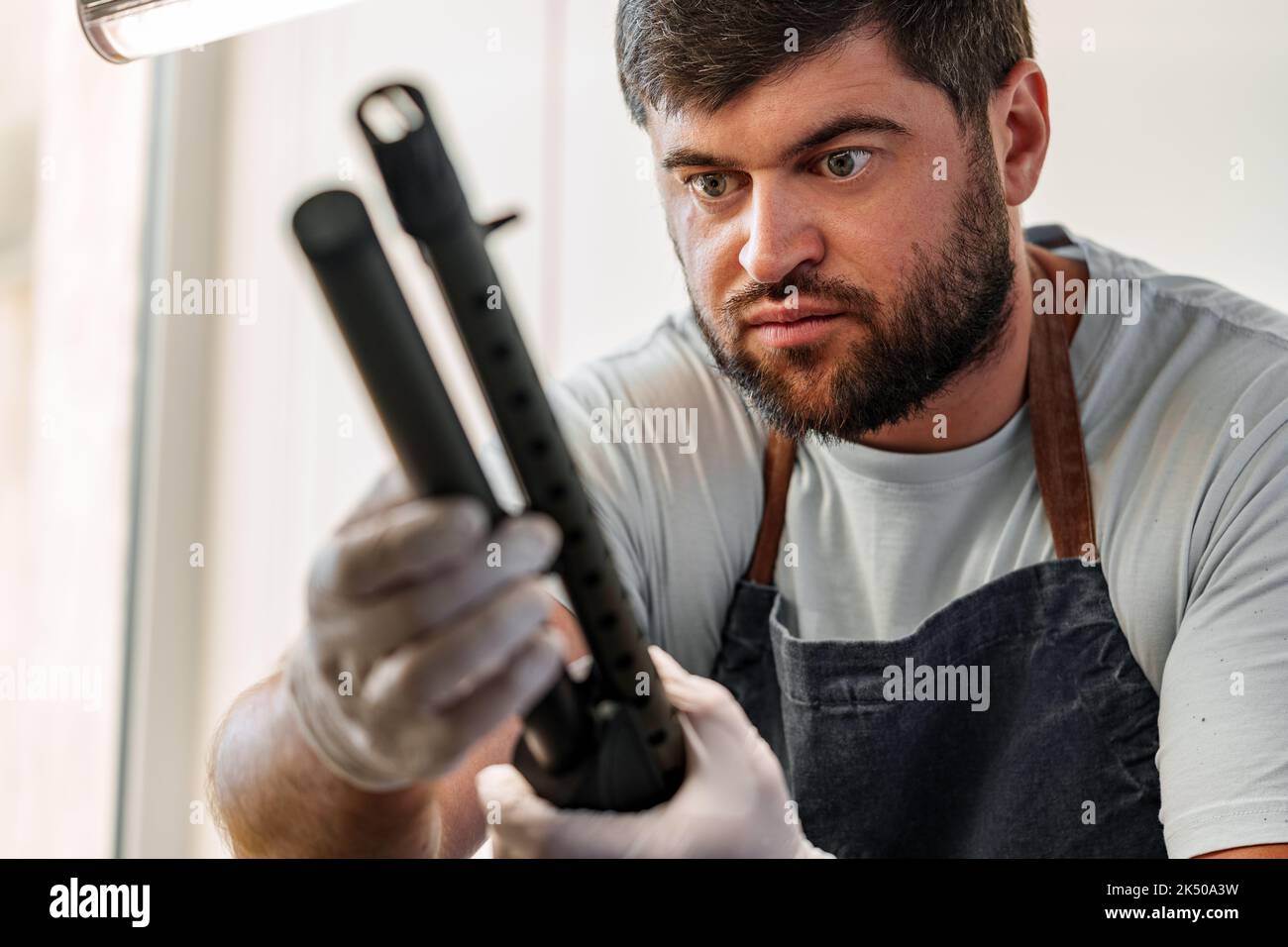 The gunsmith maintaining his rifle in a Stock Photo Alamy