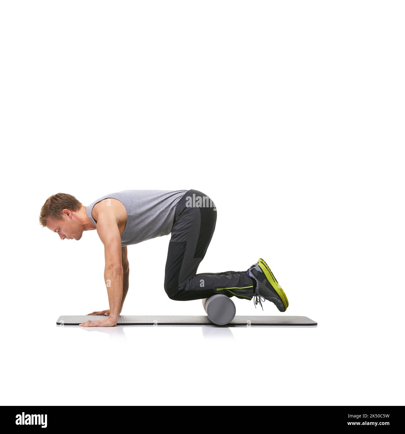 Using his foamroller to strengthen his legs. A young man doing push
