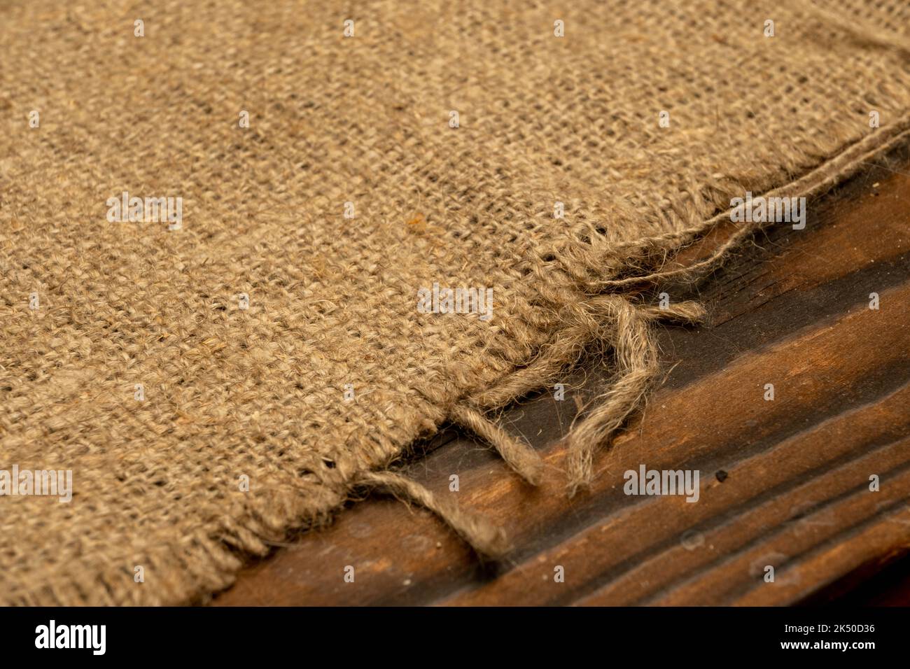 Homespun fabric with a rough texture. Close-up, selective focus. Stock Photo
