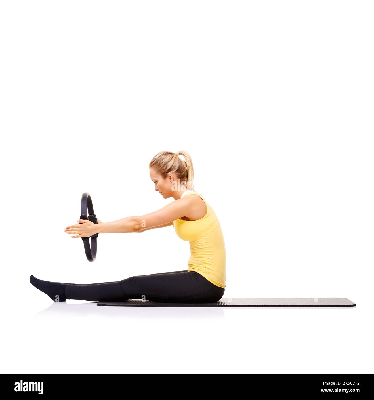 Toning her core muscles. A pretty young blonde performing the roll up