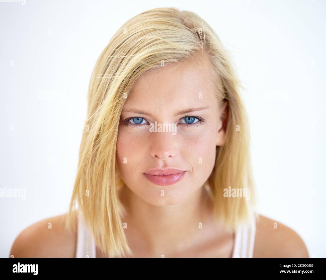 Intensity in her eyes. Head and shoulders portrait of a pretty young ...