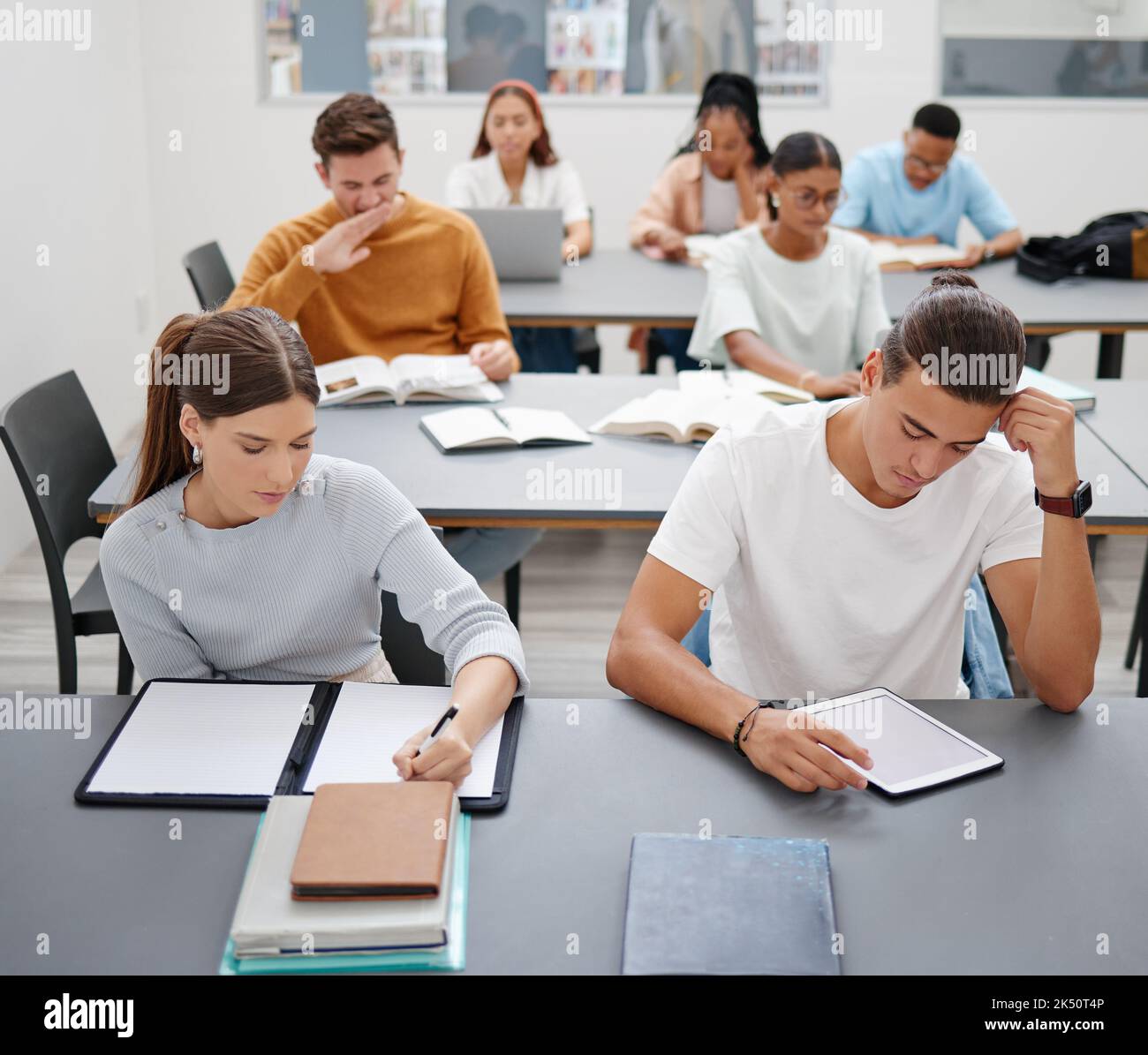 Diversity, students and university studying in classroom for higher education and training. Student groups learning at college or workshop for Stock Photo