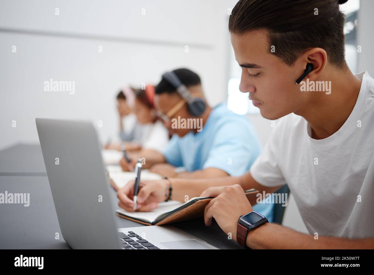 Studying, notebook and laptop with students in university classroom