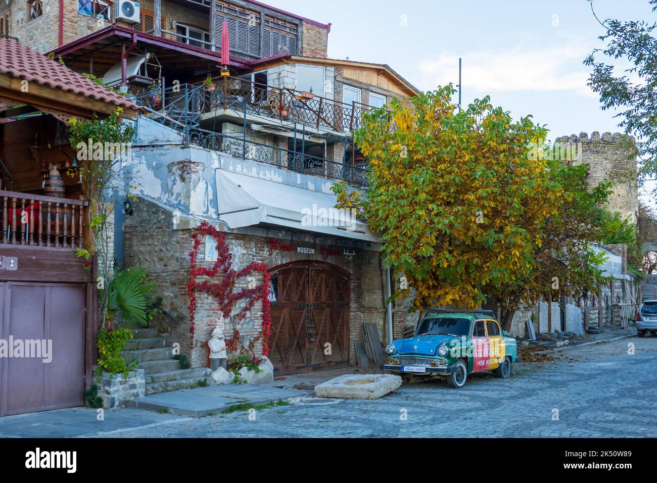 Retro car parked near aged residential houses in old town Stock Photo ...