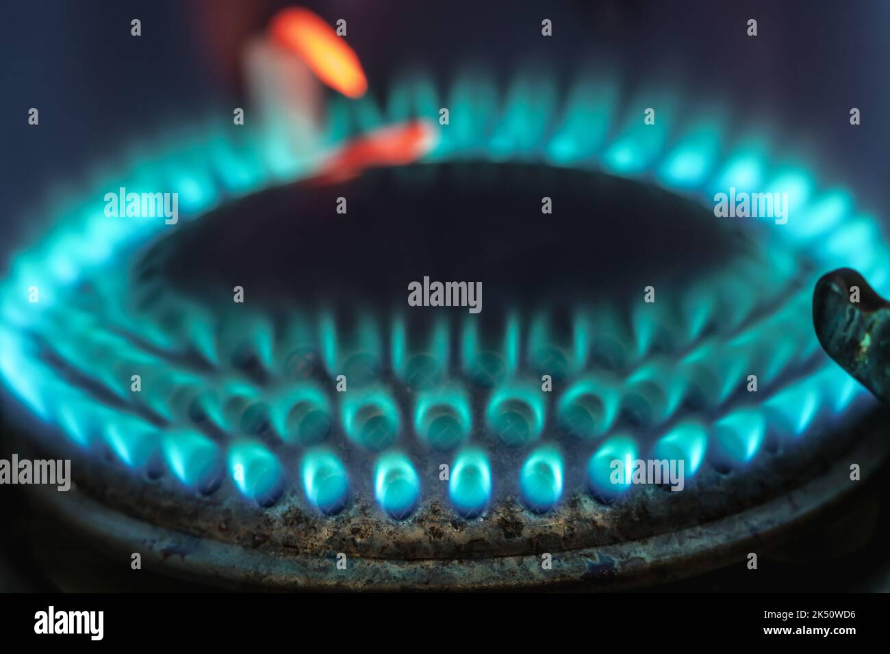 Blue flame of burning gas fire on a dark background. Gas as an energy ...
