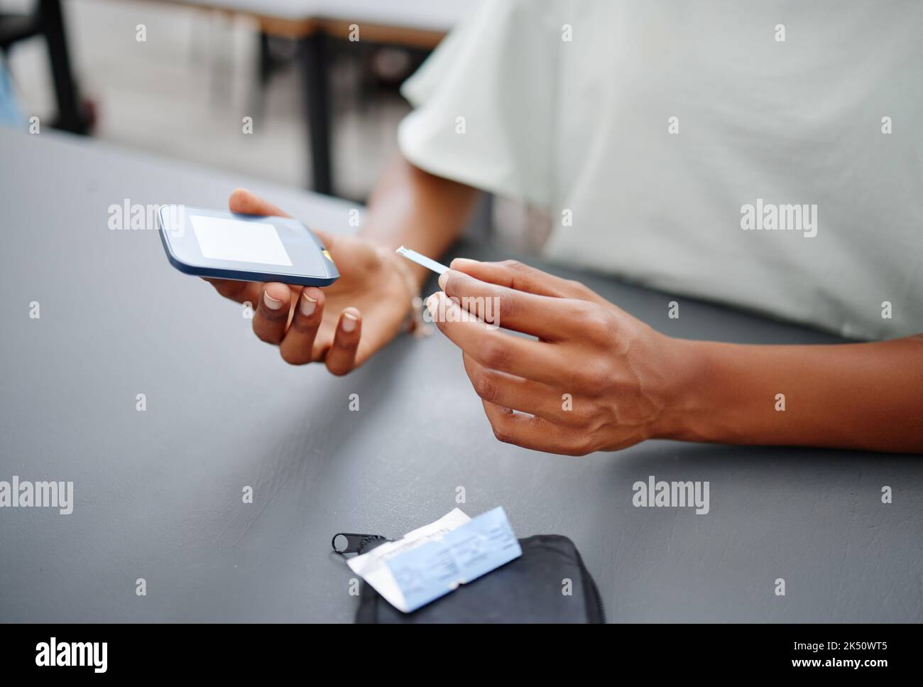 Woman Using Glucometer Diabetes, hands and black woman with glucometer on desk checking blood ...