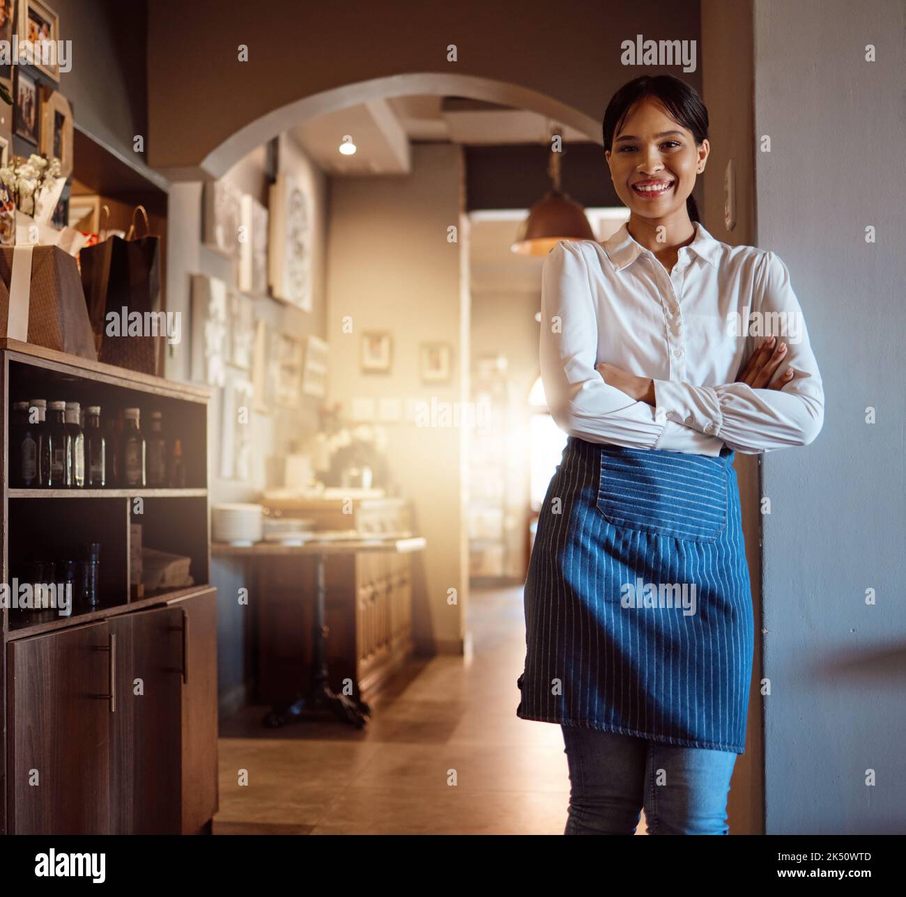 Woman at hospitality restaurant, waitress with a smile and confidence waiting for customers for dinner or lunch service. Portrait of friendly Stock Photo