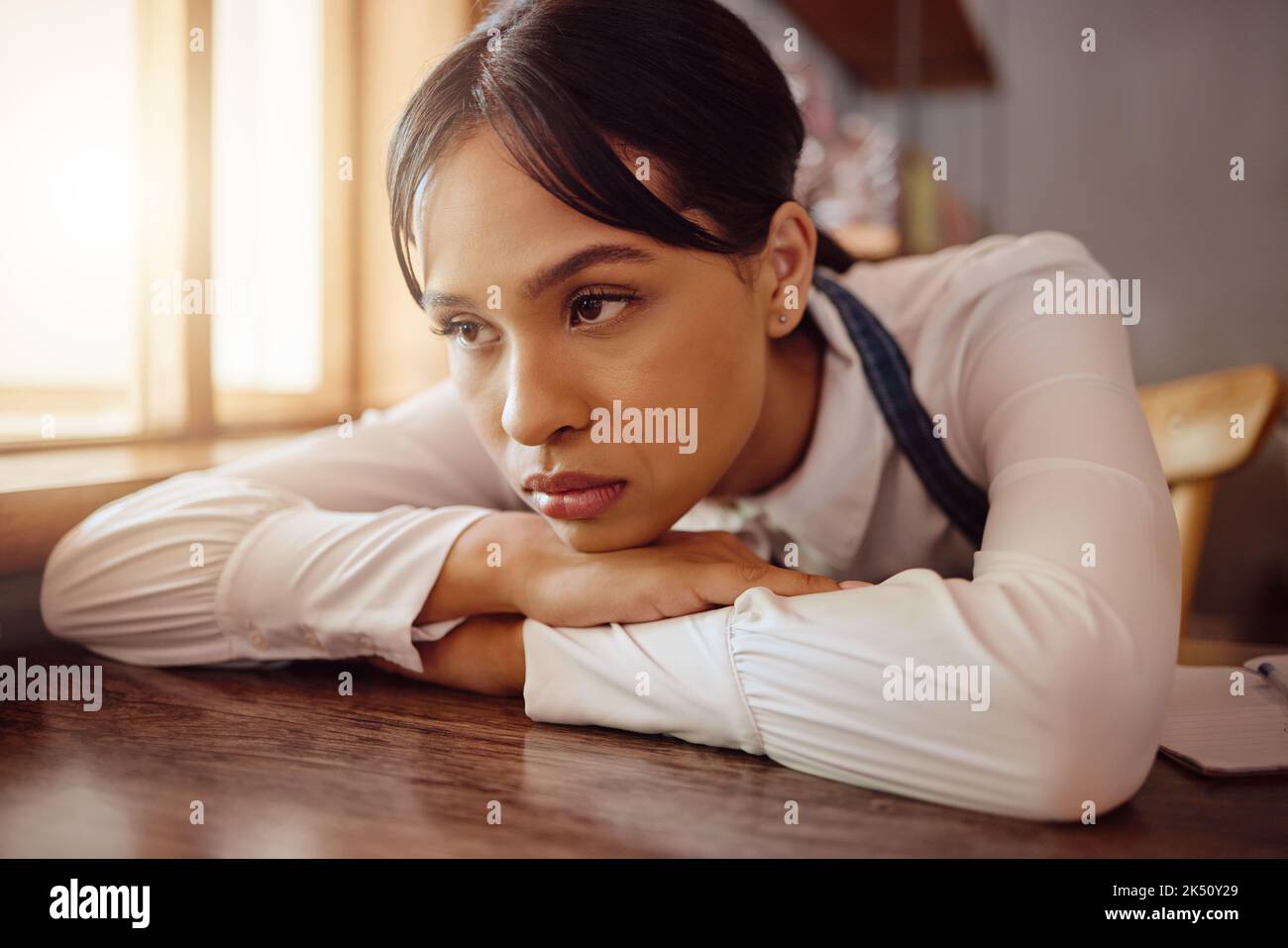 Sad waiter in Paris cafe, woman tired at table in bistro and hospitality service industry job. Disappointed face in small business, bored fatigue at Stock Photo