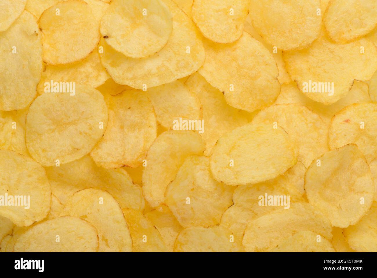 Crispy potato chips with salt texture top view pattern background Stock Photo