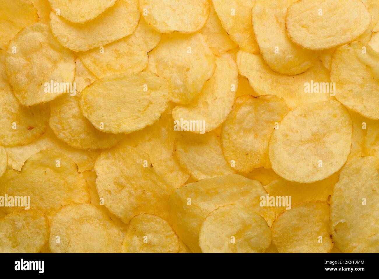 Potato chips with salt texture top view pattern background Stock Photo