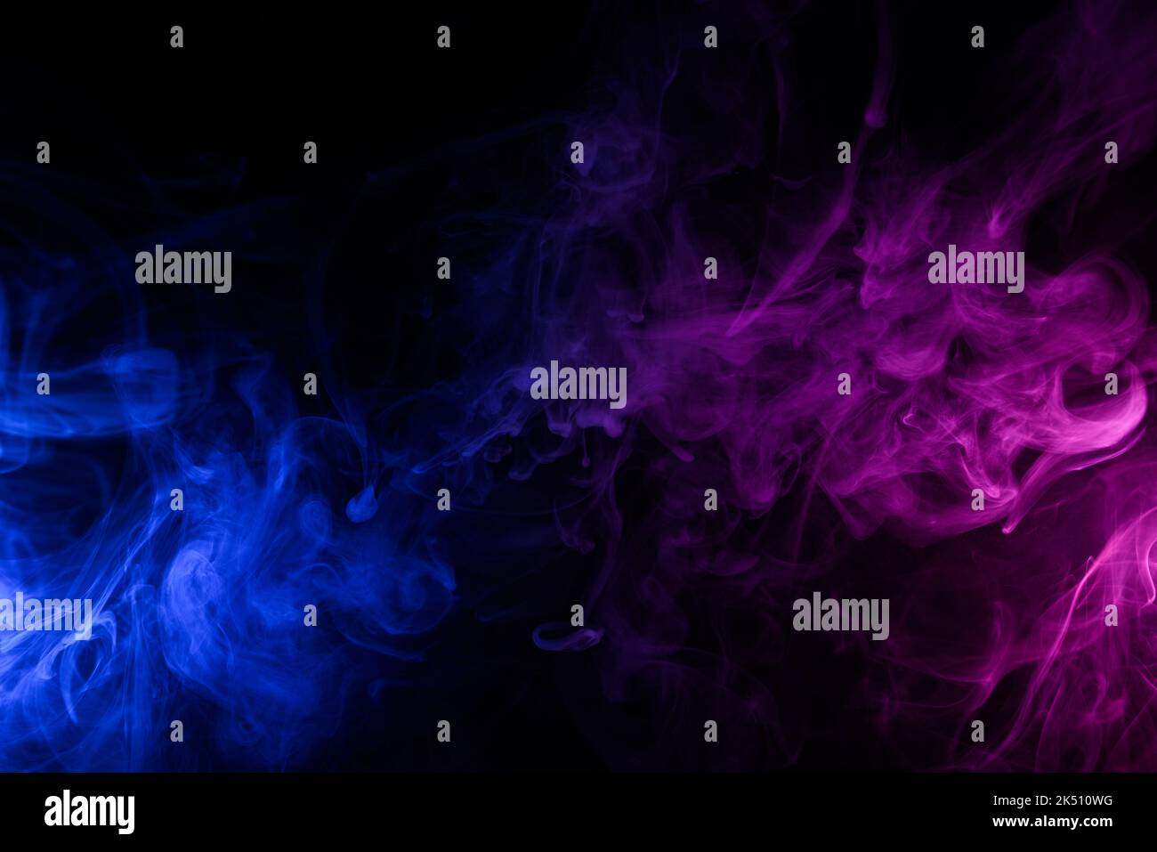 Flowing clouds of colorful swirling blue and pink smoke dark abstract ...