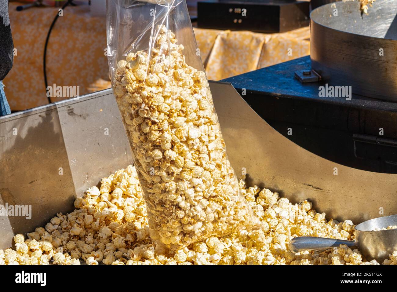 A bag of kettle corn popcorn being filled at the local county fair